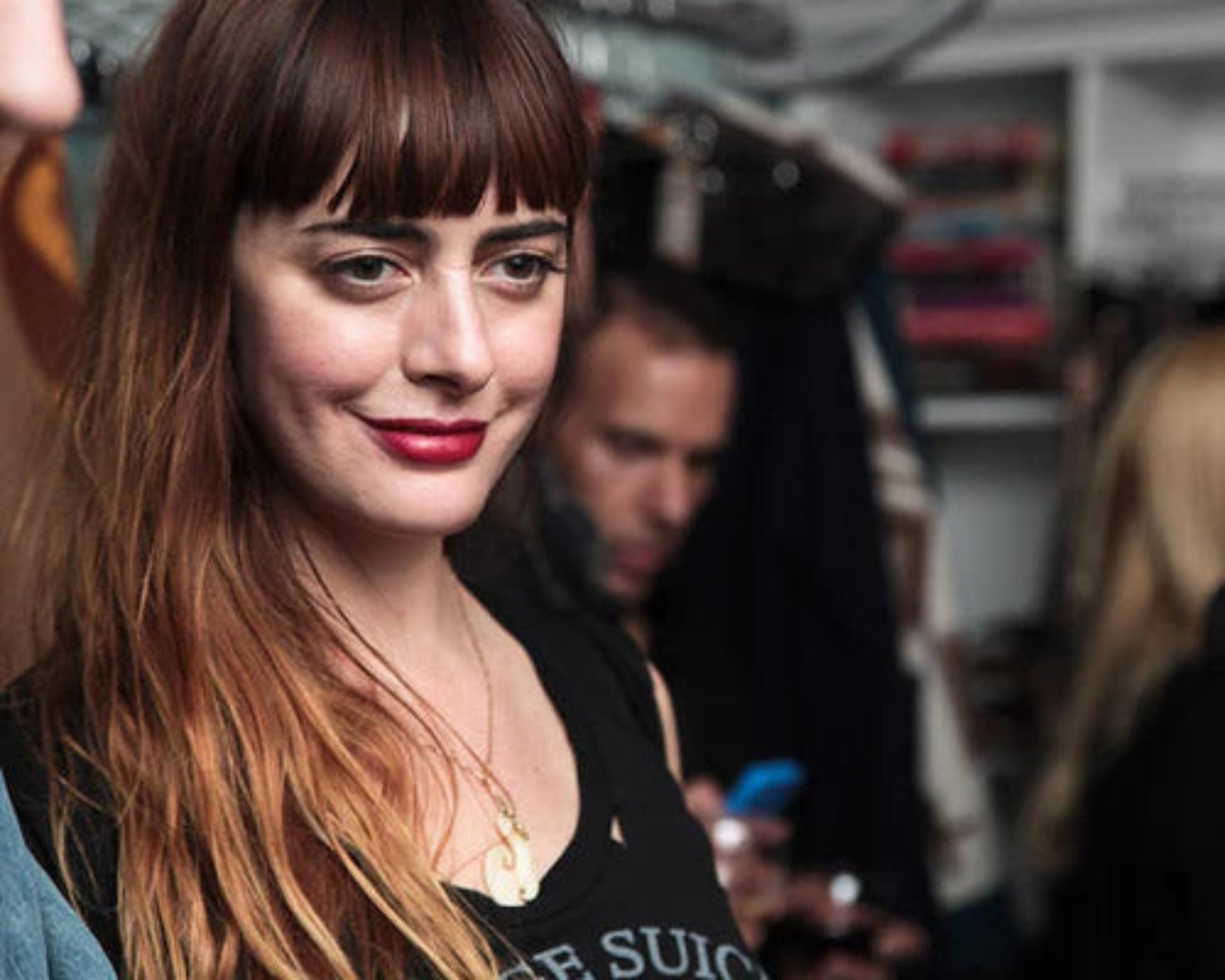 Woman with long hair and red lipstick in a casual setting