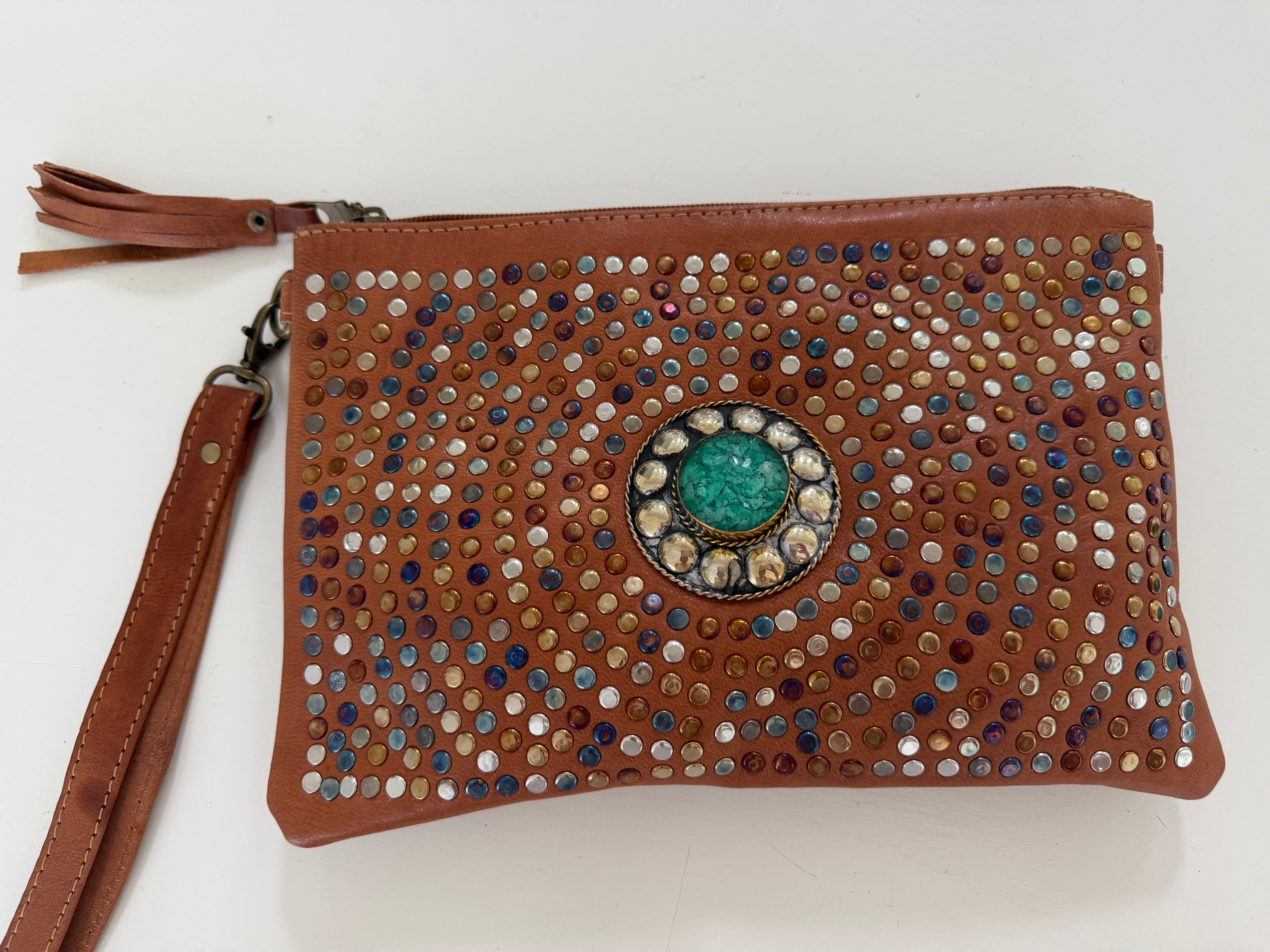 Tan leather clutch with decorative studs and a central jade  stone 